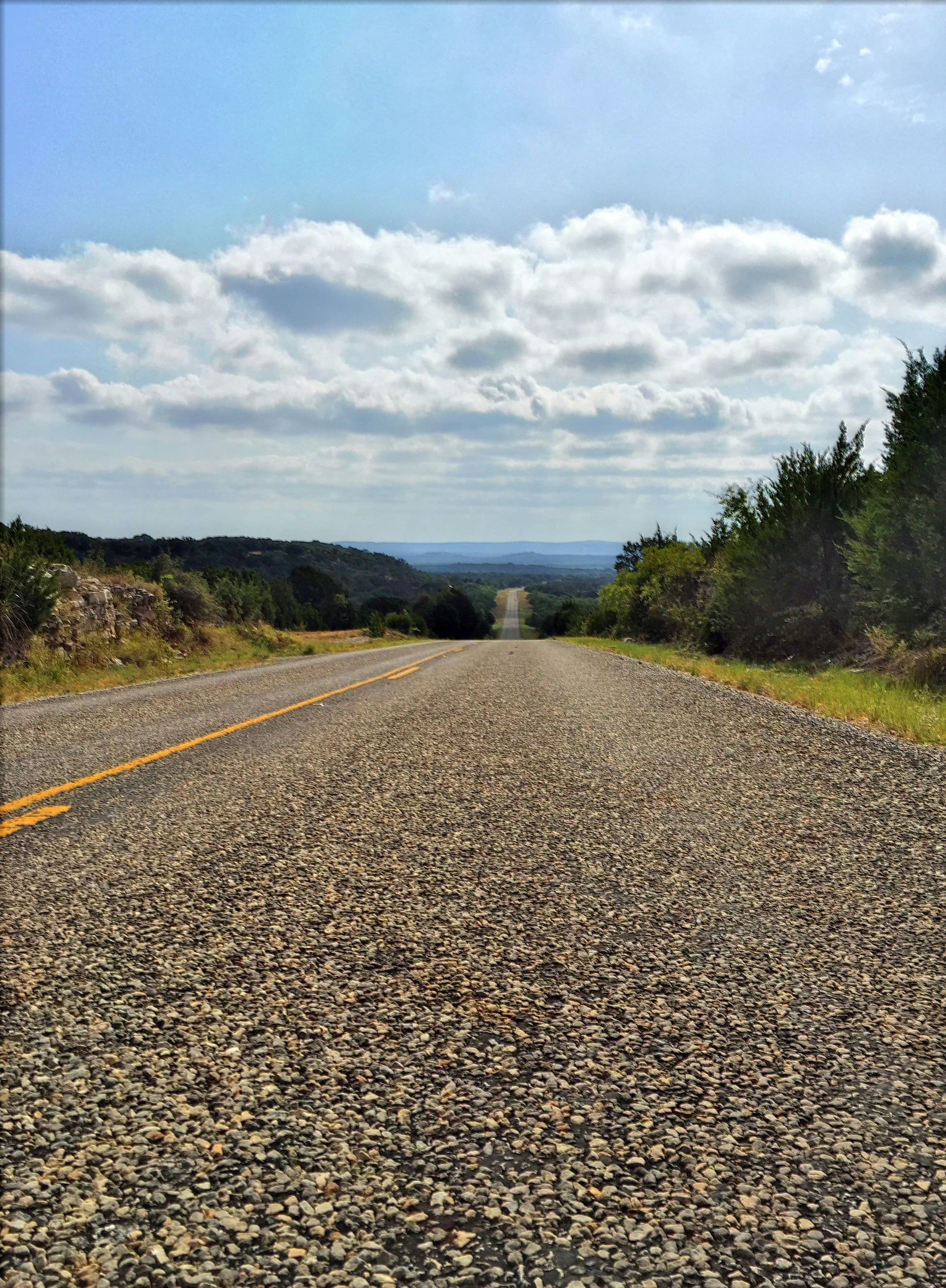 Long rural highway through the Texas countryside, highlighting the distances facing rural veterinary care