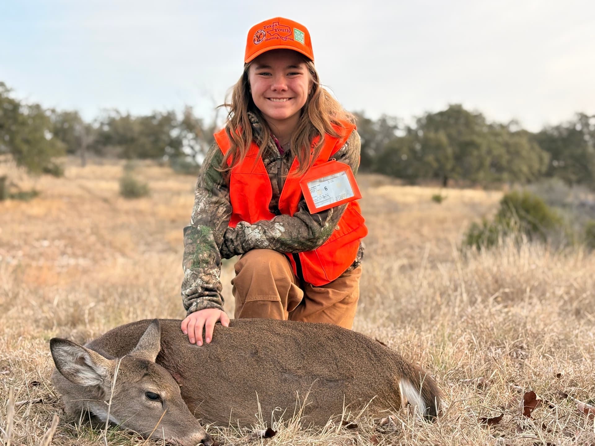 Arden with a harvested doe during a youth hunting trip in South Texas