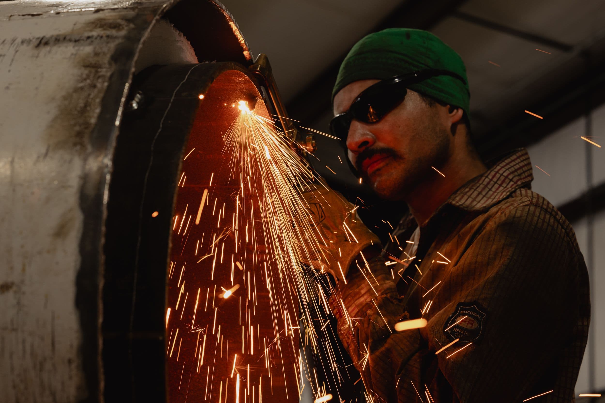 A welder works on a pit