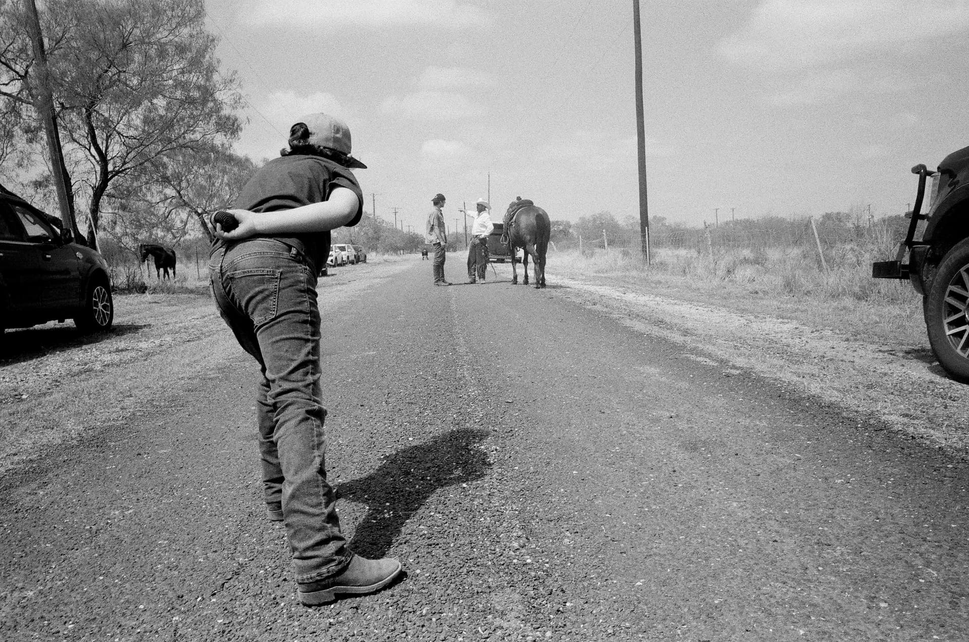 A photographer stands in a street