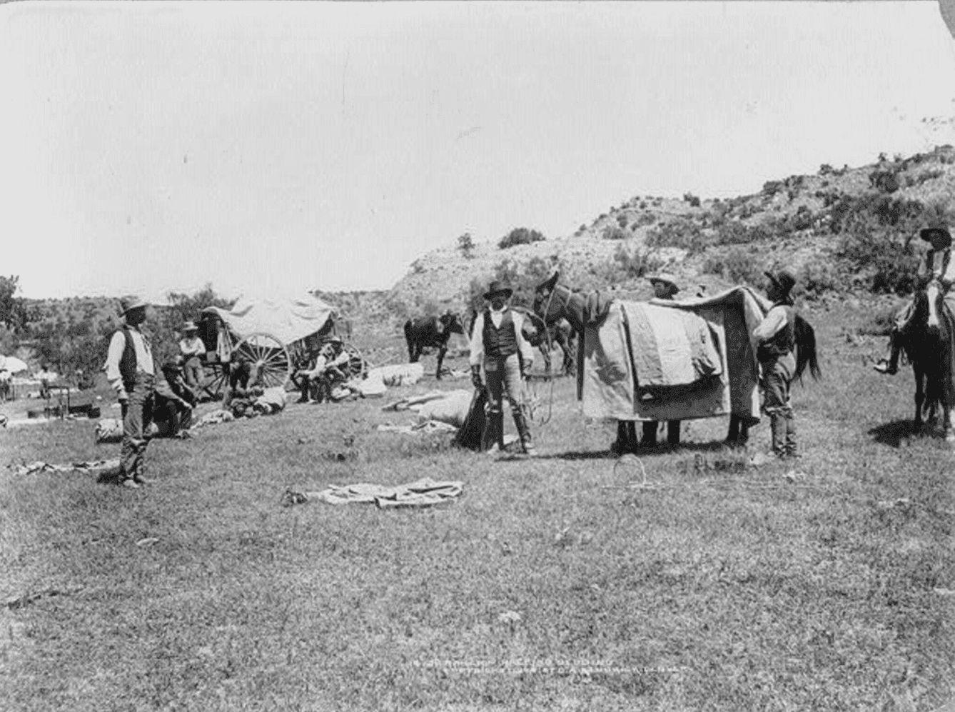 JA Ranch cowboys breaking camp on the open range in the Texas Panhandle circa 1900