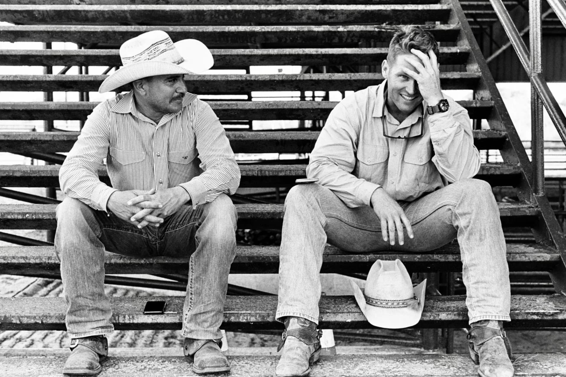 two cowboys sitting on stairs